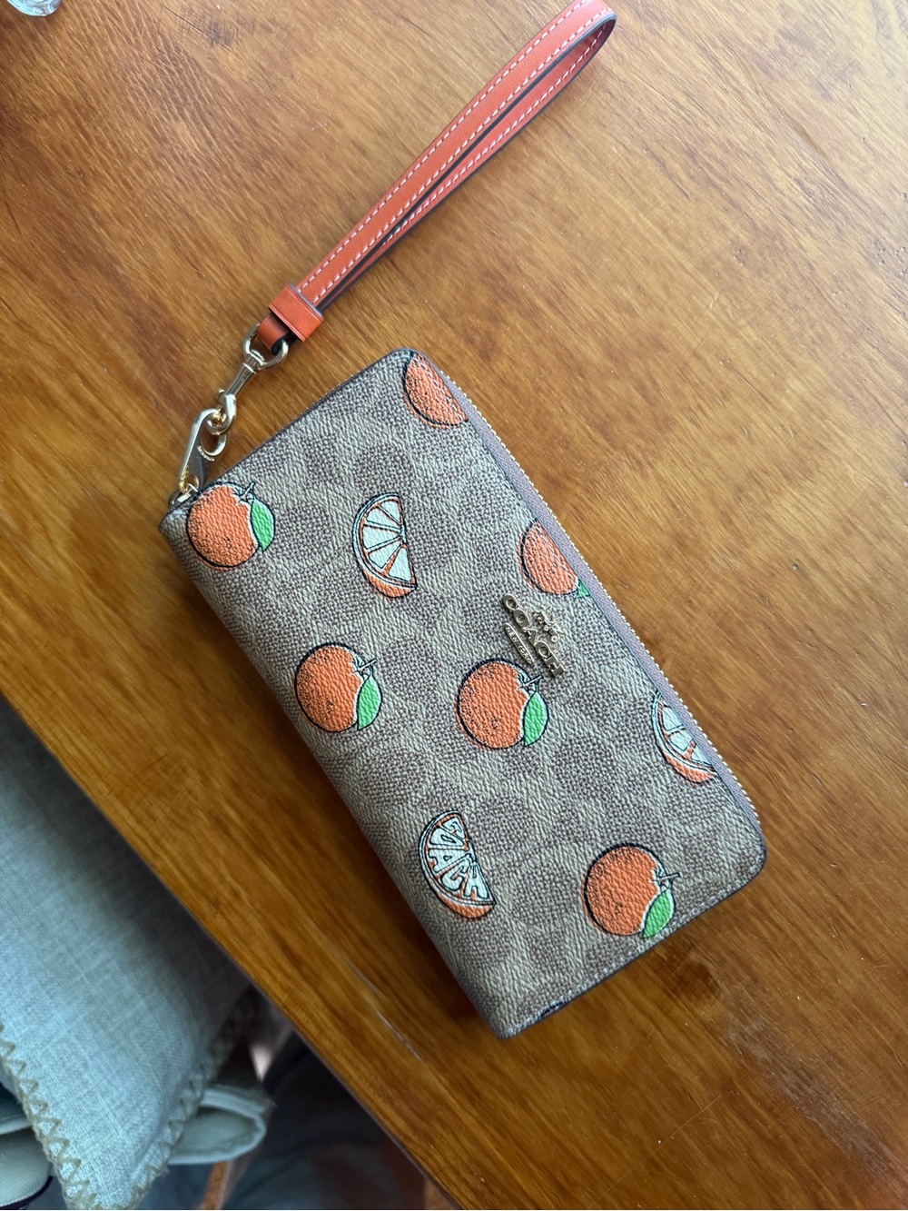 Coach Monogram Orange Print Zip Wristlet in Orange and Brown